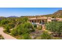 A luxurious home with an outdoor pool, lounge chairs, and beautiful desert landscape at 40853 N 94Th St, Scottsdale, AZ 85262