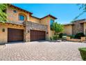 Spacious two-car garage, stone accents, and a well-maintained driveway at 40853 N 94Th St, Scottsdale, AZ 85262