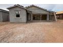 An unfinished backyard shows the beginning stages of a new construction home at 46886 W Coe St, Maricopa, AZ 85139