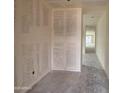 Bright hallway with smooth concrete floors leads to natural light from windows at 46886 W Coe St, Maricopa, AZ 85139