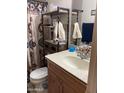 Bathroom showcasing the sink, vanity, toilet, decorative shelving and a Southwestern-themed shower curtain at 5425 N Black Cyn Hwy, Phoenix, AZ 85015