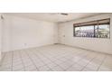 Bright bedroom with tile flooring and a window, offering a comfortable and inviting space at 5529 W Virginia Ave, Phoenix, AZ 85035