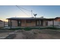 Back exterior with covered patio and mature landscaping at 5739 N 62Nd Dr, Glendale, AZ 85301
