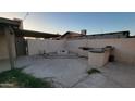 Backyard with built-in firepit and outdoor kitchen, perfect for entertaining at 5739 N 62Nd Dr, Glendale, AZ 85301