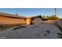 Wide driveway, offering ample space for parking, leads to gated entryway at 5739 N 62Nd Dr, Glendale, AZ 85301