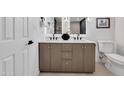 Bathroom featuring double sinks, vanity, with modern fixtures and decor at 6038 E Hobart St, Mesa, AZ 85205