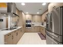 Modern kitchen featuring stainless steel appliances, light wood cabinets, and quartz countertops at 6222 N 21St Dr, Phoenix, AZ 85015