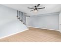 Open living room featuring stairs and light colored flooring and walls at 6565 N 19Th Ave # 45, Phoenix, AZ 85015