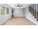 Living room with stairs, light colored walls and flooring, a window and decorations at 6565 N 19Th Ave # 45, Phoenix, AZ 85015