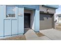 Close-up view of the townhome's front door, showing the address and the attached garage at 7430 S 75Th Dr, Laveen, AZ 85339
