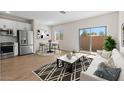 Bright living room featuring modern decor, wood floors, and a sliding glass door at 7437 S 75Th Dr, Laveen, AZ 85339