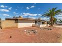 Single-story home with desert landscaping, brick wall and view of covered parking at 8033 N 56Th Ave, Glendale, AZ 85302