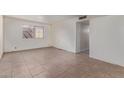 This home features an empty living room, a neutral color palette, and durable tile flooring at 8033 N 56Th Ave, Glendale, AZ 85302