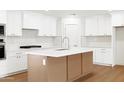 Stylish kitchen with white cabinets, an island, and stainless steel appliances at 8334 E Palm Ln, Scottsdale, AZ 85257