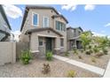 Two-story home with neutral stucco, well-manicured yard, and a inviting walkway leading up to the front entrance at 8343 E Irwin Ave, Mesa, AZ 85209