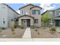 Charming two-story home with a well-maintained yard, neutral colored stucco, and a welcoming walkway to the front door at 8343 E Irwin Ave, Mesa, AZ 85209