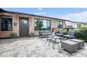 Cozy outdoor patio with modern seating, a stylish rug, and a paved stone floor at 8425 E Bonnie Rose Ave, Scottsdale, AZ 85250