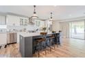 Modern kitchen featuring stainless steel appliances, a large island, and sliding glass doors to the outdoor area at 8455 E Orange Blossom Ln, Scottsdale, AZ 85250