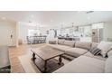 Spacious living area with open layout, hardwood floors, dining area, and kitchen island with modern appliances at 8455 E Orange Blossom Ln, Scottsdale, AZ 85250
