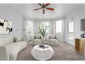 Bright, staged living room features neutral furniture, modern decor, and a ceiling fan providing comfortable elegance at 9820 N Central Ave # 224, Phoenix, AZ 85020