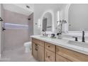 Modern bathroom features double sinks, backlit mirrors, and a tiled walk-in shower with sleek fixtures at 1142 E Encinas Ave, Gilbert, AZ 85234