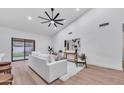 Open living area with wood floors, white walls, modern decor, and a sliding door to the outdoor space at 1142 E Encinas Ave, Gilbert, AZ 85234