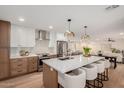 Modern kitchen features a large island with seating, stainless steel appliances, and stylish pendant lighting at 12 E Seminole Dr, Phoenix, AZ 85022