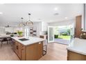 Spacious kitchen with a large island, modern appliances, and access to the backyard at 12 E Seminole Dr, Phoenix, AZ 85022