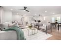 Bright living room featuring modern furniture, a ceiling fan, and an open floor plan at 12 E Seminole Dr, Phoenix, AZ 85022
