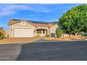 Well-kept home featuring a two-car garage, low-maintenance landscaping, and energy-efficient solar panels at 18161 N 63Rd Ln, Glendale, AZ 85308