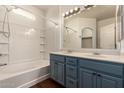 Bright bathroom featuring a double vanity, tub, and shower with tile surround at 18250 N Cave Creek Rd # 139, Phoenix, AZ 85032