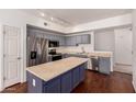 Modern kitchen with stainless steel appliances, island, and light gray cabinets at 18250 N Cave Creek Rd # 139, Phoenix, AZ 85032