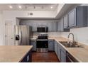 Stylish kitchen with stainless appliances, a microwave, and dark wood floors at 18250 N Cave Creek Rd # 139, Phoenix, AZ 85032