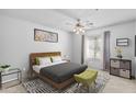 Bright bedroom featuring a cozy bed, ceiling fan, window with natural light, and stylish decor at 2201 N Comanche Dr # 1094, Chandler, AZ 85224