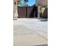 View of the tall, dark brown, wood-paneled gate to the side yard at 23833 N 39Th N Ln, Glendale, AZ 85310