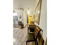 Hallway with wood floors, yellow door, and table with chairs at 23833 N 39Th N Ln, Glendale, AZ 85310