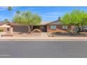 Lovely single-story brick home featuring desert landscaping and a two-car garage at 2524 E Elmwood St, Mesa, AZ 85213