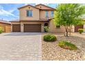 Charming home featuring desert landscaping, a three-car garage, and a cozy front entrance at 26116 N Thornhill Dr, Peoria, AZ 85383