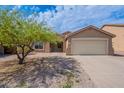 Charming single-story home with desert landscaping, a two-car garage, and a tree at 2745 W Sunshine Butte Dr, San Tan Valley, AZ 85144