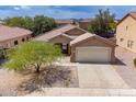 Inviting single-story home with a two-car garage and desert landscaping at 2745 W Sunshine Butte Dr, San Tan Valley, AZ 85144