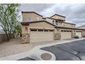 Attached garage with stylish stone accents and low maintenance desert landscaping at 2821 S Skyline Dr # 149, Mesa, AZ 85212