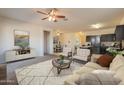 Open-concept living room flows into the dining area and kitchen with neutral tones and modern decor at 29870 W Weldon Ave, Buckeye, AZ 85396