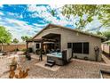 Spacious backyard showcasing a relaxing hot tub and covered patio with pergola at 29915 N Maravilla Dr, San Tan Valley, AZ 85143