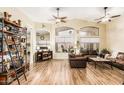 Bright living room with high ceilings, wood floors, and ample natural light at 29915 N Maravilla Dr, San Tan Valley, AZ 85143