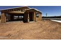 New construction home showcasing the early stages of construction with lumber and framework at 32615 N Newby Dr, San Tan Valley, AZ 85143