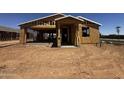 Image of new construction home with lumber and framework, showcasing its early stage of completion at 32615 N Newby Dr, San Tan Valley, AZ 85143