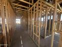 Interior framework of new construction showcasing lumber beams and open floorplan at 32615 N Newby Dr, San Tan Valley, AZ 85143