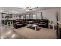 Spacious living room featuring a comfortable leather sectional, neutral carpet, and lots of natural light at 3730 S Chaparral Rd, Apache Junction, AZ 85119