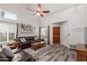 Cozy living room with ample natural light, comfortable seating, and a decorative ceiling fan at 4106 E Muirwood Dr, Phoenix, AZ 85048