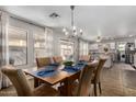 Open dining area with modern chandelier, tile floors, and access to the backyard at 424 W Midland Ln, Gilbert, AZ 85233